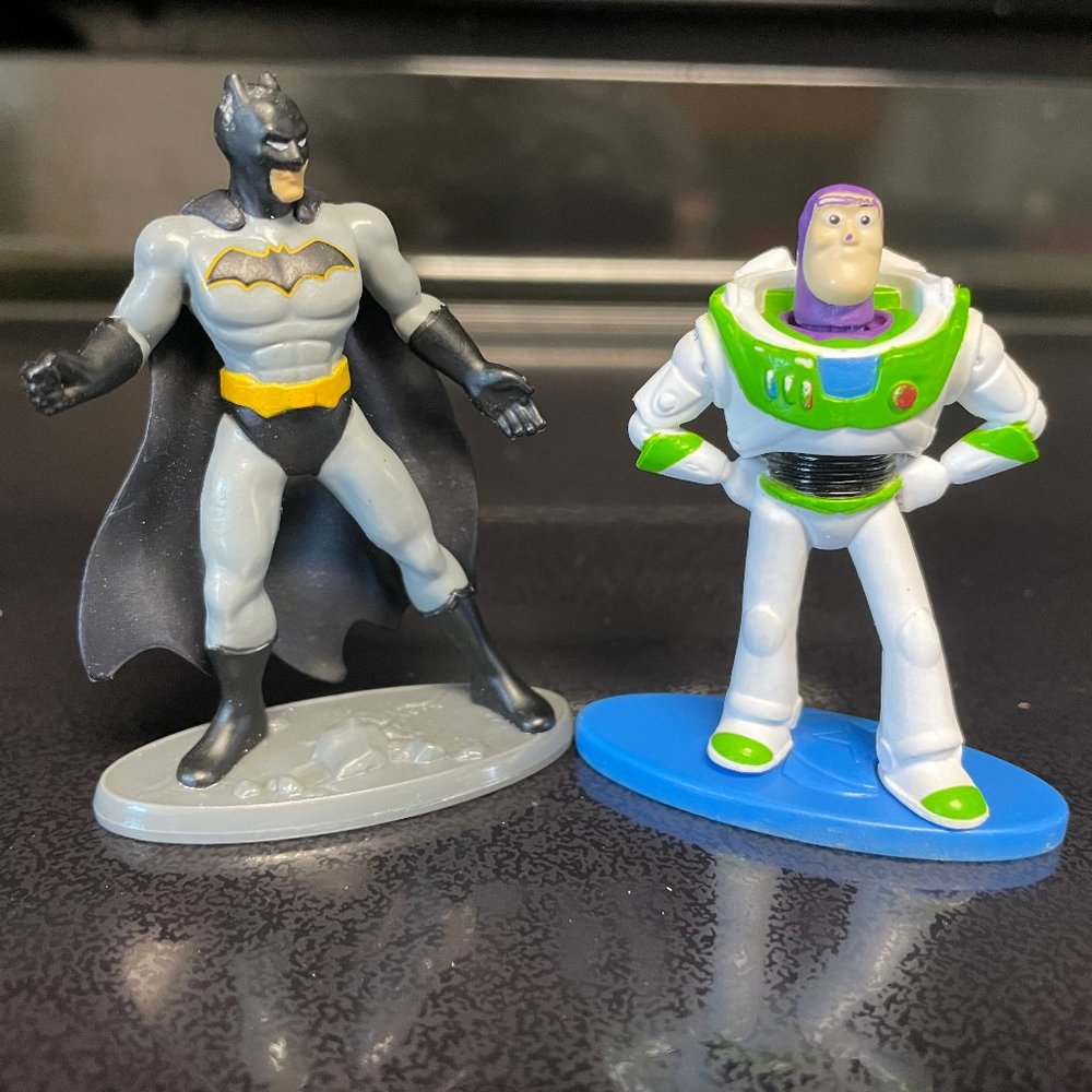 Superman and Buzz Lightyear figureines